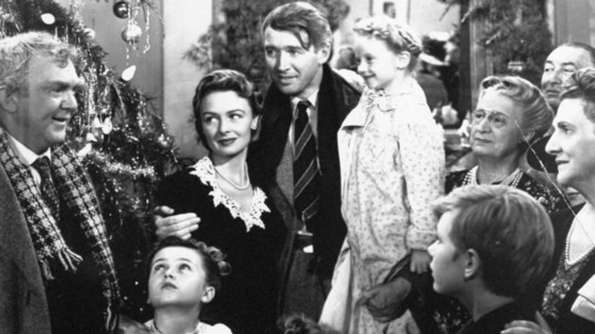**FILE** In this undated publicity still photo, James Stewart, center, is reunited with his wife, Donna Reed, left, and children during the last scene of Frank Capra's 1946 classic, 