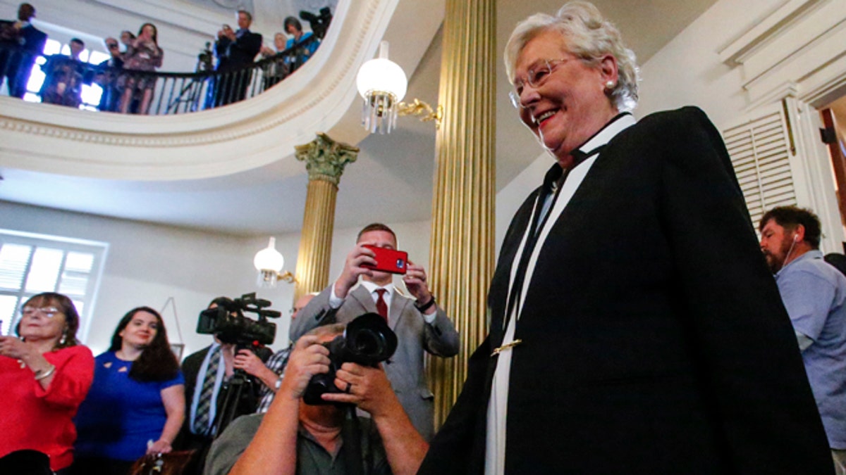 Kay Ivey walks in to be sworn in as the next Governor of Alabama, Monday, April 10, 2017, in Montgomery, Ala. (AP Photo/Butch Dill)