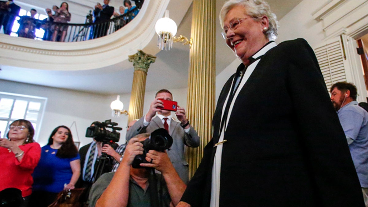 Kay Ivey walks in to be sworn in as the next Governor of Alabama, Monday, April 10, 2017, in Montgomery, Ala. (AP Photo/Butch Dill)