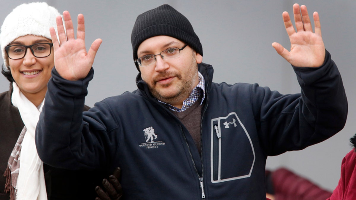 U.S. journalist Jason Rezaian gestures next to his wife Yeganeh Salehi as he poses for media people in front of Landstuhl Regional Medical Center in Landstuhl, Germany, Wednesday, Jan. 20, 2016. Rezaian was released from an Iranian prison last Saturday. (AP Photo/Michael Probst)