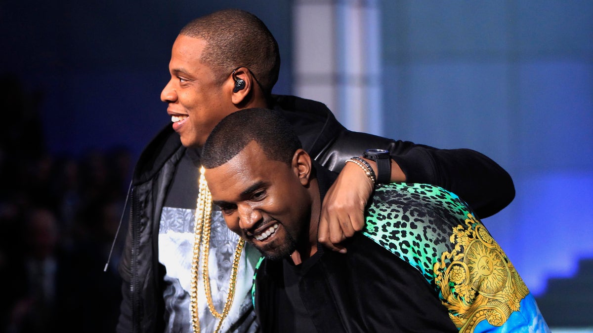 Rappers Jay-Z (L) puts his arm around Kanye West as they walk off stage after performing during the Victoria's Secret Fashion Show at the Lexington Armory in New York November 9, 2011. REUTERS/Lucas Jackson (UNITED STATES - Tags: ENTERTAINMENT) - RTR2TT6S
