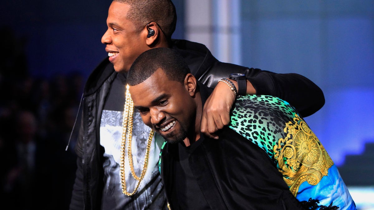 Rappers Jay-Z (L) puts his arm around Kanye West as they walk off stage after performing during the Victoria's Secret Fashion Show at the Lexington Armory in New York November 9, 2011. REUTERS/Lucas Jackson (UNITED STATES - Tags: ENTERTAINMENT) - RTR2TT6S