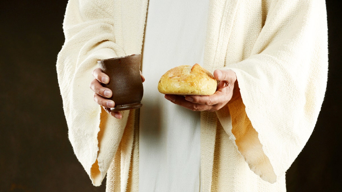 Jesus holding bread and a cup of wine