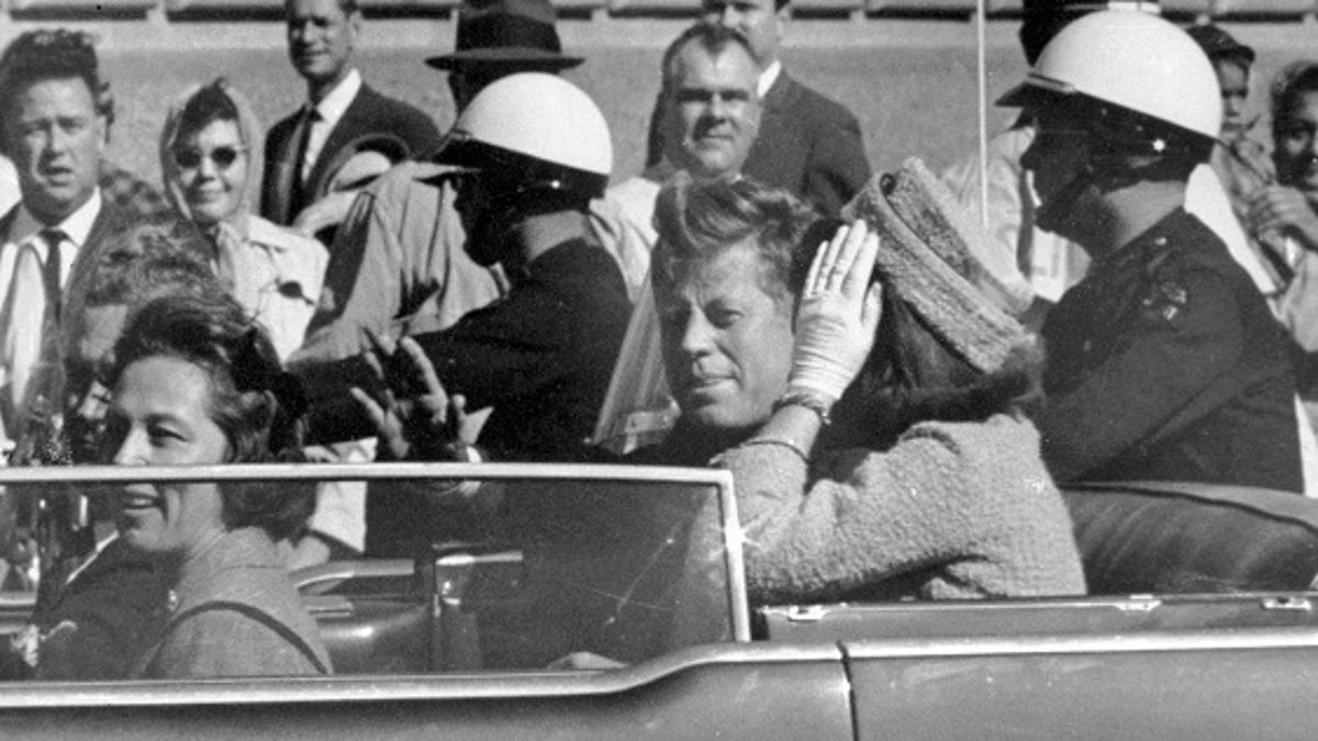 FILE - In this Nov. 22, 1963 file photo, President John F. Kennedy waves from his car in a motorcade in Dallas. Riding with Kennedy are First Lady Jacqueline Kennedy, right, Nellie Connally, second from left, and her husband, Texas Gov. John Connally, far left. President Donald Trump, on Saturday, Oct. 21, 2017, says he plans to release thousands of never-seen government documents related to President John F. Kennedy's assassination. (AP Photo/Jim Altgens, File)
