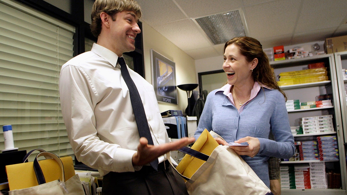 Actors John Krasinski (L) and Jenna Fischer interact as they receive gift bags from the Screen Actors Guild Awards Committee including a certificate for their nomination for an outstanding performance by an ensemble in a comedy series in 