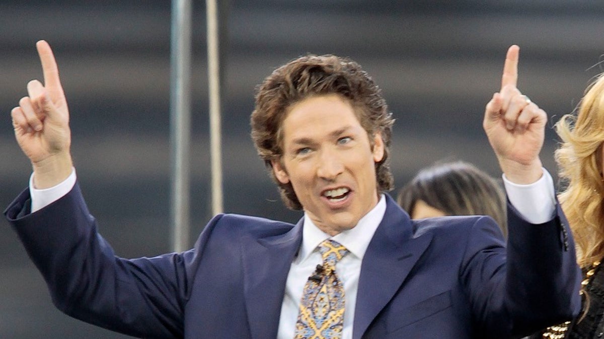 FILE - This April 24, 2010 file photo shows Lakewood Church pastor Joel Osteen at Dodger Stadium during his "A Night of Hope" in Los Angeles. Osteen said in a statement to ABC News on Aug. 28, 2017, that his Lakewood Church would open as a shelter for Hurricane Harvey victims if needed. (AP Photo/Richard Vogel, File)
