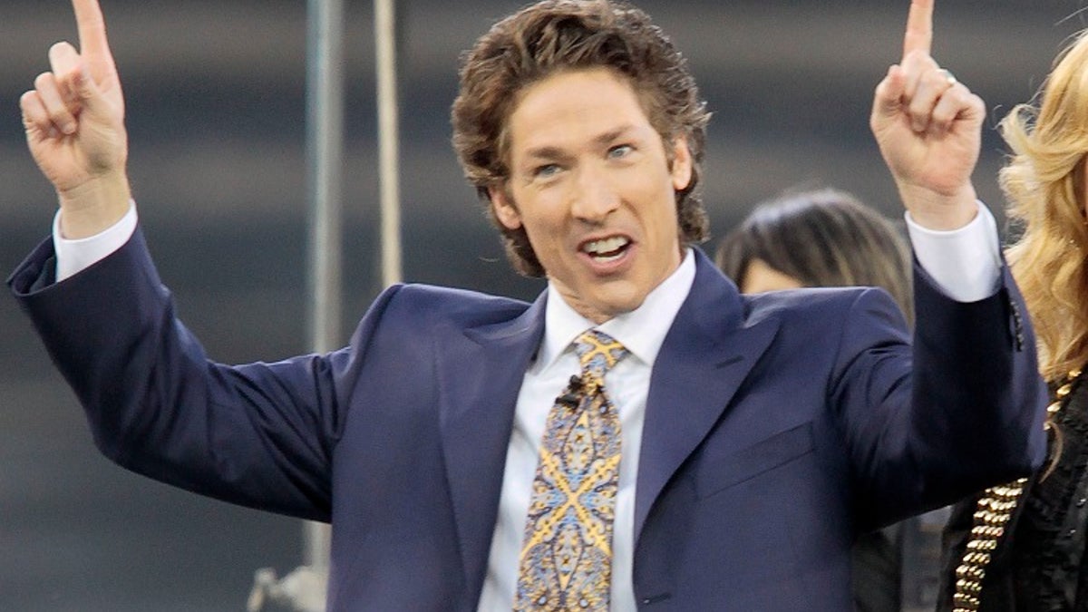 FILE - This April 24, 2010 file photo shows Lakewood Church pastor Joel Osteen at Dodger Stadium during his "A Night of Hope" in Los Angeles. Osteen said in a statement to ABC News on Aug. 28, 2017, that his Lakewood Church would open as a shelter for Hurricane Harvey victims if needed. (AP Photo/Richard Vogel, File)