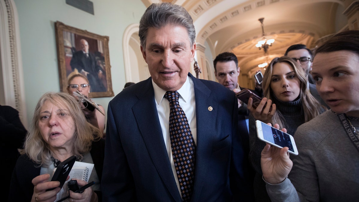 Sen. Joe Manchin, D-W.Va., is surrounded by reporters looking for news of a breakthrough to avoid a government shutdown, at the Capitol in Washington, Friday, Jan. 19, 2018. (AP Photo/J. Scott Applewhite)