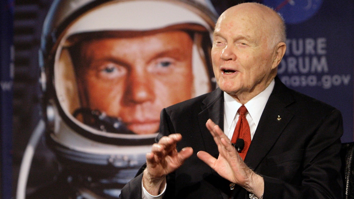 FILE - In this Feb. 20, 2012, file photo, U.S. Sen. John Glenn talks with astronauts on the International Space Station via satellite before a discussion titled "Learning from the Past to Innovate for the Future" in Columbus, Ohio. The 94-year-old former U.S. senator and his wife are scheduled to appear at a ceremony Tuesday, June 28, 2016, to rename Port Columbus International Airport in Ohio's capital city as John Glenn Columbus International Airport. (AP Photo/Jay LaPrete, File)