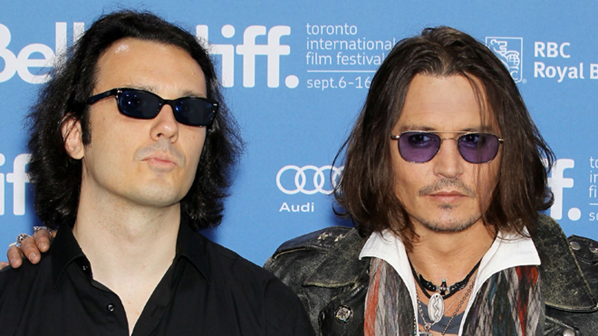 This image released by Starpix shows Damien Echols, one of the West Memphis Three, left, and actor Johnny Depp at a press conference for the film 