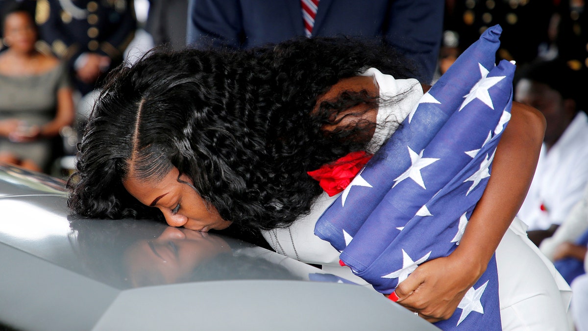 Myeshia Johnson, wife of U.S. Army Sergeant La David Johnson, who was among four special forces soldiers killed in Niger, kisses his coffin at a graveside service in Hollywood, Florida, October 21, 2017. REUTERS/Joe Skipper TPX IMAGES OF THE DAY - RC17B5AF3250