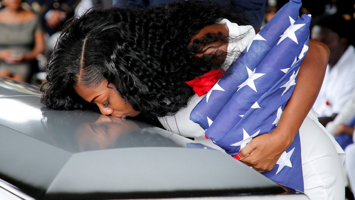 Myeshia Johnson, wife of U.S. Army Sergeant La David Johnson, who was among four special forces soldiers killed in Niger, kisses his coffin at a graveside service in Hollywood, Florida, October 21, 2017. REUTERS/Joe Skipper TPX IMAGES OF THE DAY - RC17B5AF3250