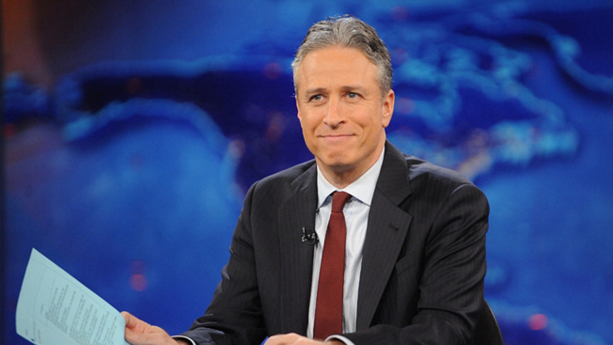 FILE - This Nov. 30, 2011 file photo shows television host Jon Stewart during a taping of "The Daily Show with Jon Stewart" in New York. Stewart says Aug. 6, 2015 will be his last night hosting Comedy Centrals The Daily Show. Stewart set the date in the closing moments of Monday, April 20 edition of the parody newscast. (AP Photo/Brad Barket, file)