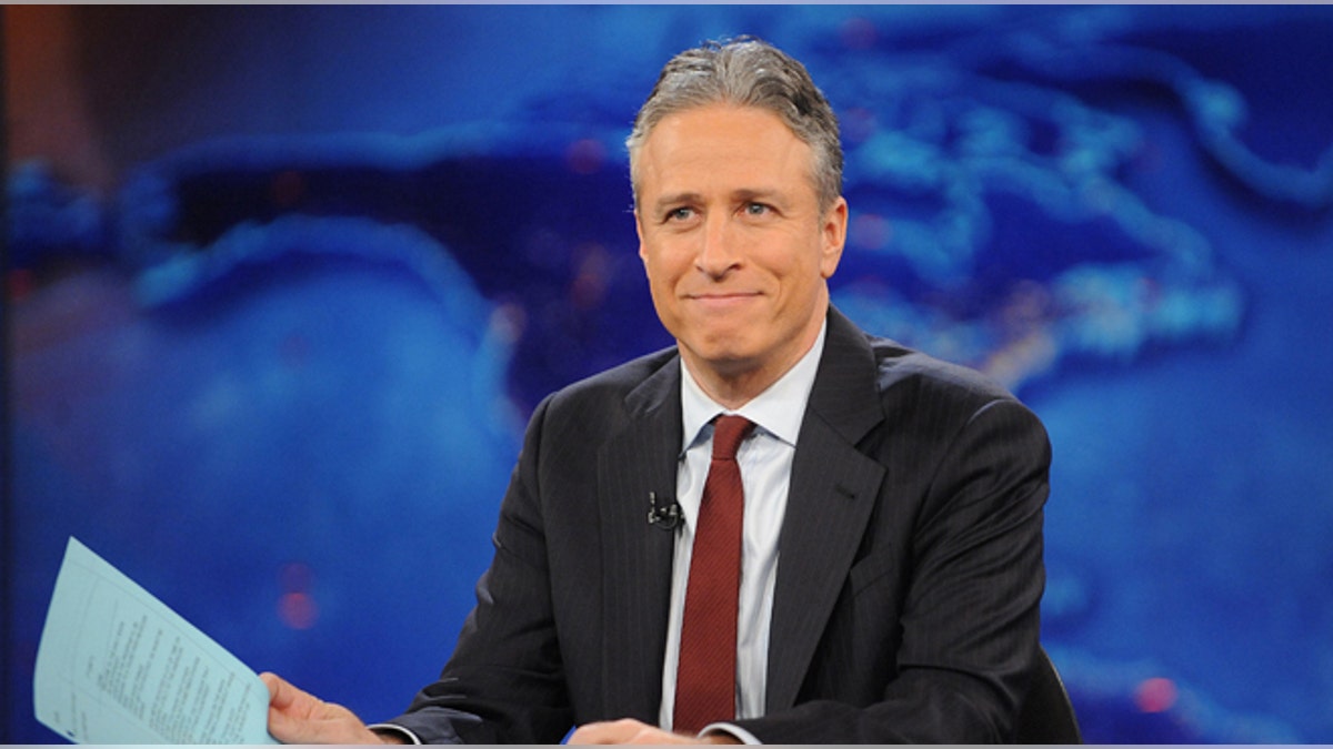 FILE - This Nov. 30, 2011 file photo shows television host Jon Stewart during a taping of "The Daily Show with Jon Stewart" in New York. Stewart says Aug. 6, 2015 will be his last night hosting Comedy Centrals The Daily Show. Stewart set the date in the closing moments of Monday, April 20 edition of the parody newscast. (AP Photo/Brad Barket, file)