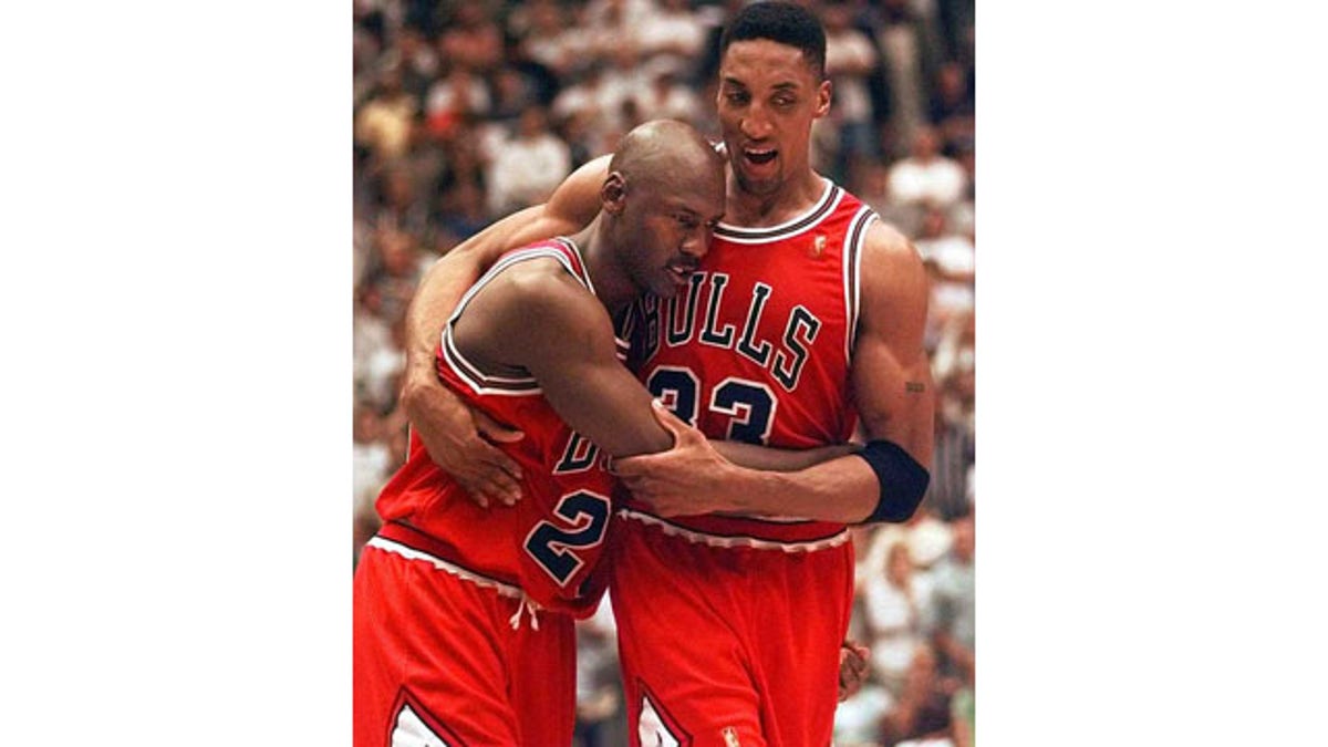 June 11, 1997: Scottie Pippen, right, helps Michael Jordan off the floor following Game 5 of the NBA Finals between the Chicago Bulls and Utah Jazz. Jordan scored 38 points in Chicago's 90-88 win despite playing with a severe stomach flu. (AP Photo)