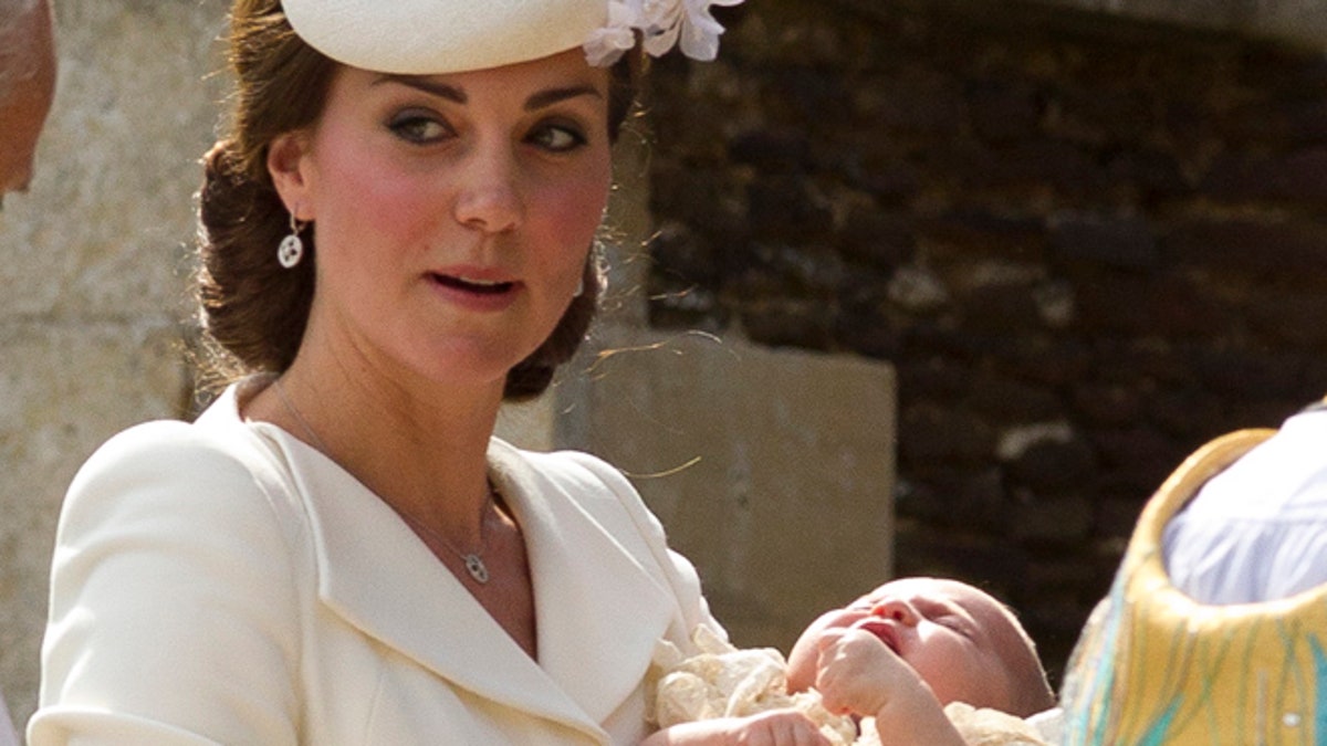 July 5, 2015: Britain's Kate the Duchess of Cambridge carries Princess Charlotte after taking her out of a pram as they arrive for Charlotte's Christening at St. Mary Magdalene Church in Sandringham, England.