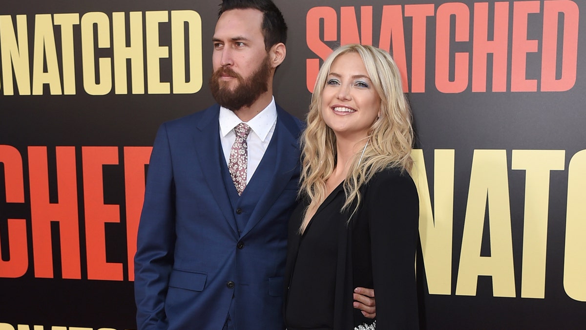 Danny Fujikawa, left, and Kate Hudson arrive at the Los Angeles premiere of "Snatched" at the Regency Village Theatre on Wednesday, May 10, 2017. (Photo by Jordan Strauss/Invision/AP)