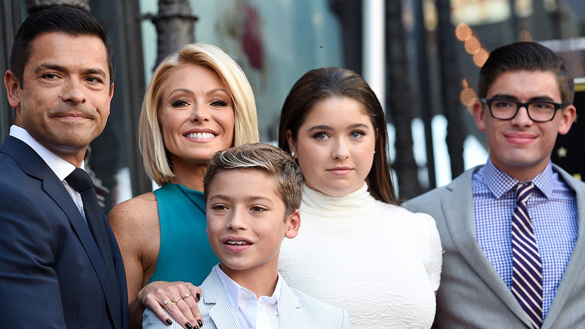 Television personality Kelly Ripa, second from left, poses with, from left, her husband Mark Consuelos and their children Joaquin, Michael and Lola during a ceremony to award Ripa a star on the Hollywood Walk of Fame on Monday, Oct. 12, 2015, in Los Angeles. (Photo by Chris Pizzello/Invision/AP)