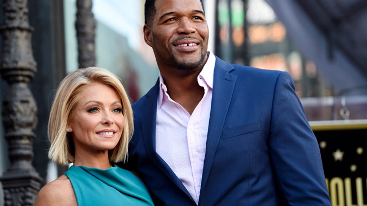 FILE - In this Oct. 12, 2015 file photo, Kelly Ripa, left, poses with Michael Strahan, her co-host on the daily television talk show 