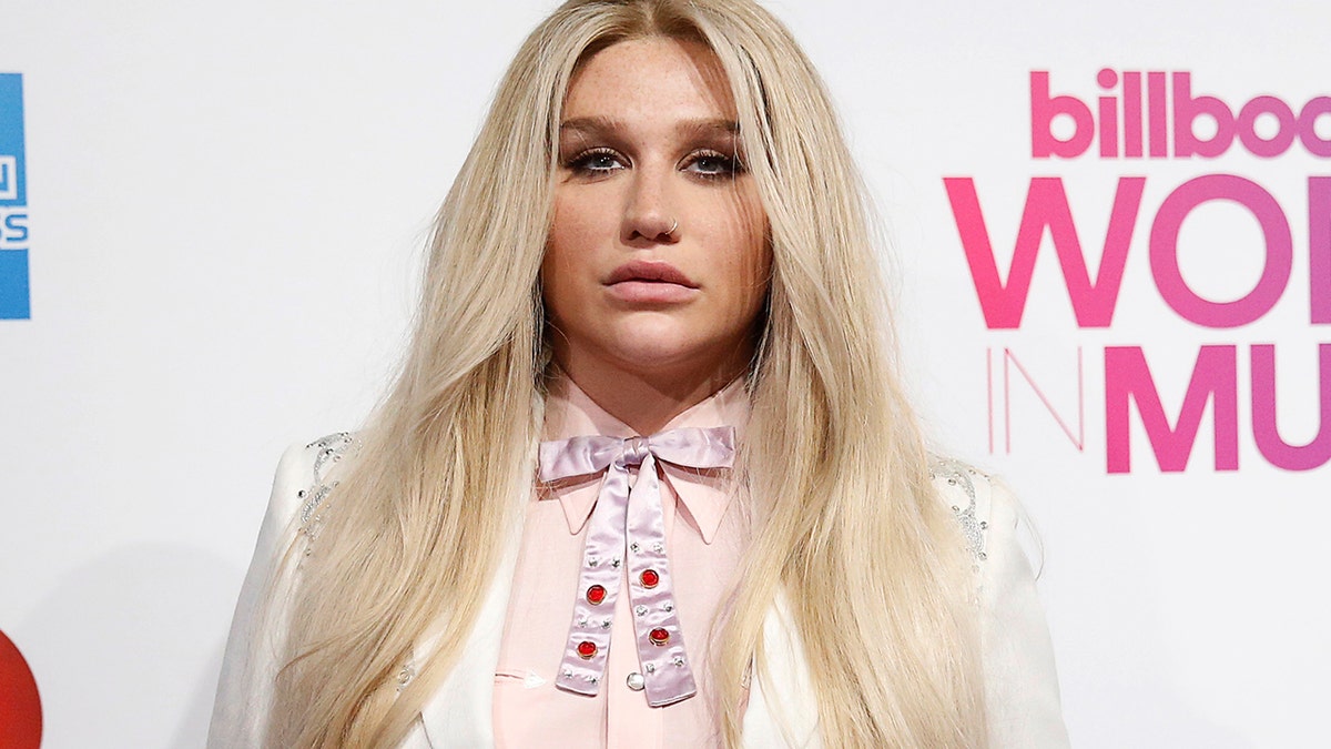 Kesha poses on the red carpet a the Billboard Magazine's 11th annual Women in Music luncheon in New York December 9, 2016.