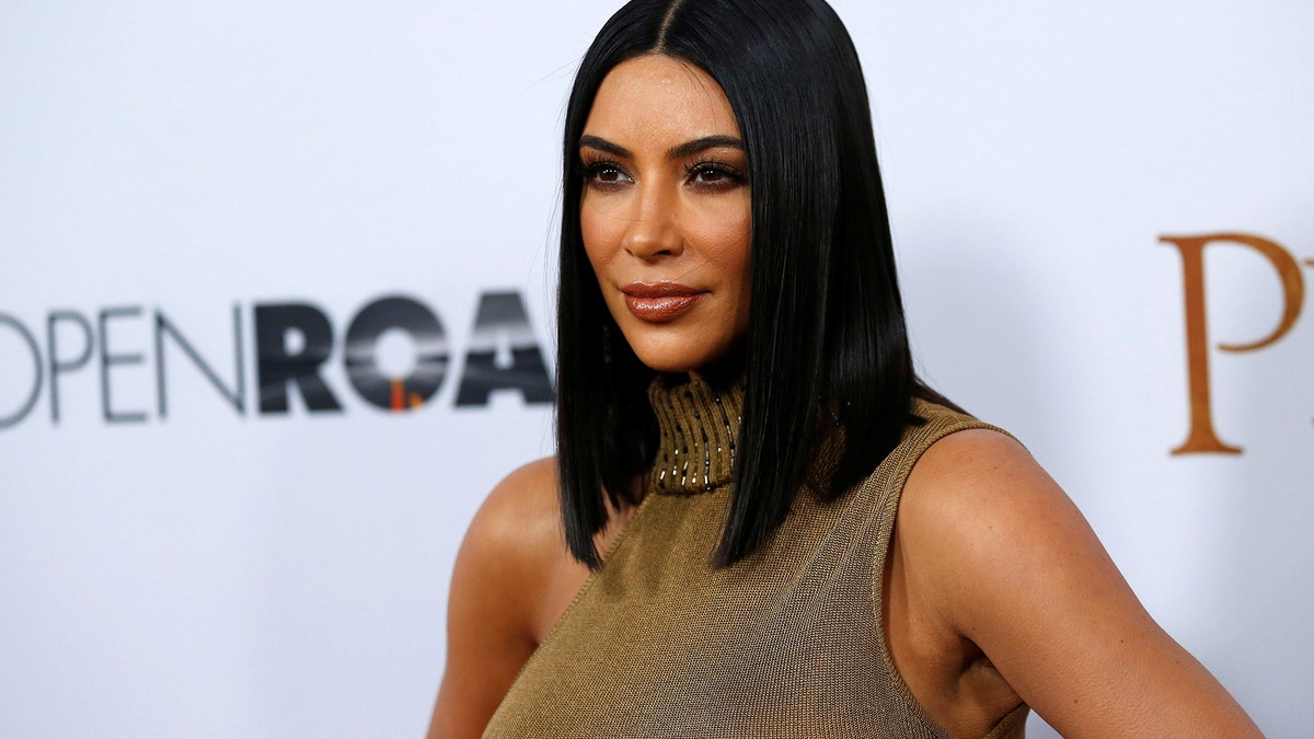 Television personality Kim Kardashian poses at the premiere of 