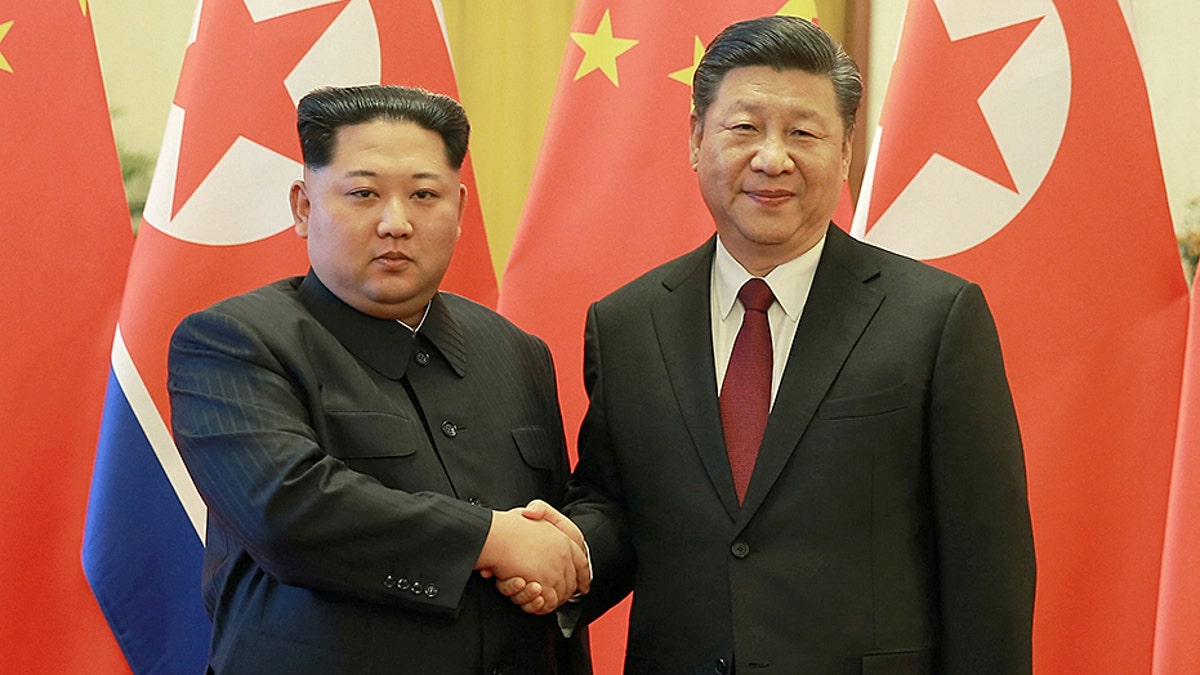 North Korean leader Kim Jong Un shakes hands with Chinese President Xi Jinping in Beijing, as he paid an unofficial visit to China, in this undated photo released by North Korea's Korean Central News Agency (KCNA) in Pyongyang March 28, 2018. KCNA/via Reuters ATTENTION EDITORS - THIS IMAGE WAS PROVIDED BY A THIRD PARTY. REUTERS IS UNABLE TO INDEPENDENTLY VERIFY THIS IMAGE. NO THIRD PARTY SALES. NOT FOR USE BY REUTERS THIRD PARTY DISTRIBUTORS. SOUTH KOREA OUT. NO COMMERCIAL OR EDITORIAL SALES IN SOUTH KOREA. - RC138FE3D980