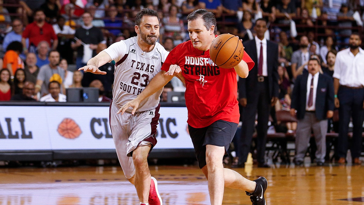 Senator Ted Cruz dribbles past Jimmy Kimmel during the Blobfish Basketball Classic and one-on-one interview at Texas Southern University's Health & Physical Education Arena Saturday, June 16, 2018 in Houston. Cruz challenged Kimmel to the game after Kimmel blamed the Houston Rockets playoff loss on the senator. Cruz won 11-9. (Michael Ciaglo/Houston Chronicle via AP)