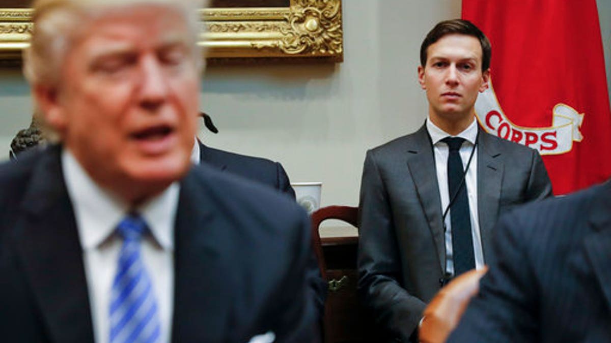 FILE - In this Monday, Jan. 23, 2017, file photo, White House Senior Adviser Jared Kushner, right, listens to President Donald Trump speak during a breakfast with business leaders in the Roosevelt Room of the White House in Washington. Trump is set to announce a new White House office run by his son-in-law, Kushner, that will seek to overhaul government functions using ideas from the business sector. (AP Photo/Pablo Martinez Monsivais, File)