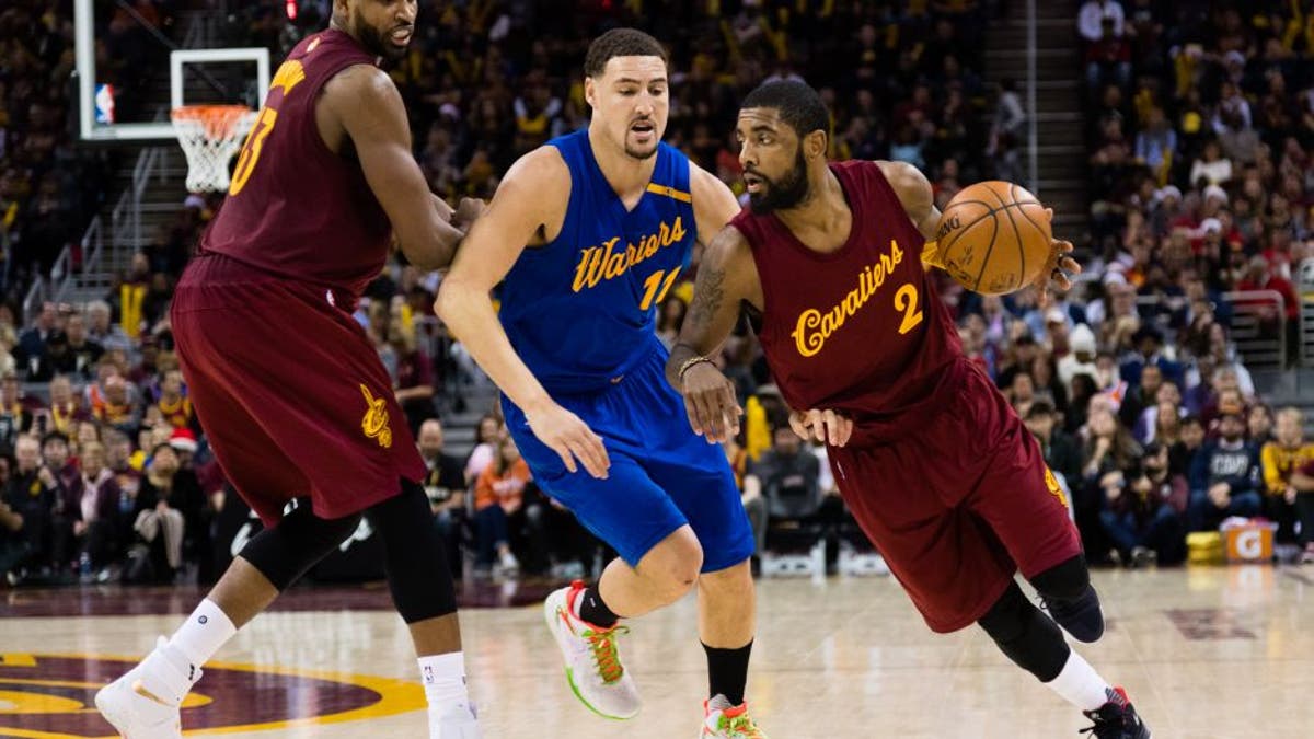 CLEVELAND, OH - DECEMBER 25: Tristan Thompson #13 sets a pick as Kyrie Irving #2 of the Cleveland Cavaliers drives around Klay Thompson #11 of the Golden State Warriors during the second half at Quicken Loans Arena on December 25, 2016 in Cleveland, Ohio. The Cavaliers defeated the Warriors 109-108. NOTE TO USER: User expressly acknowledges and agrees that, by downloading and/or using this photograph, user is consenting to the terms and conditions of the Getty Images License Agreement. Mandatory copyright notice. (Photo by Jason Miller/Getty Images)