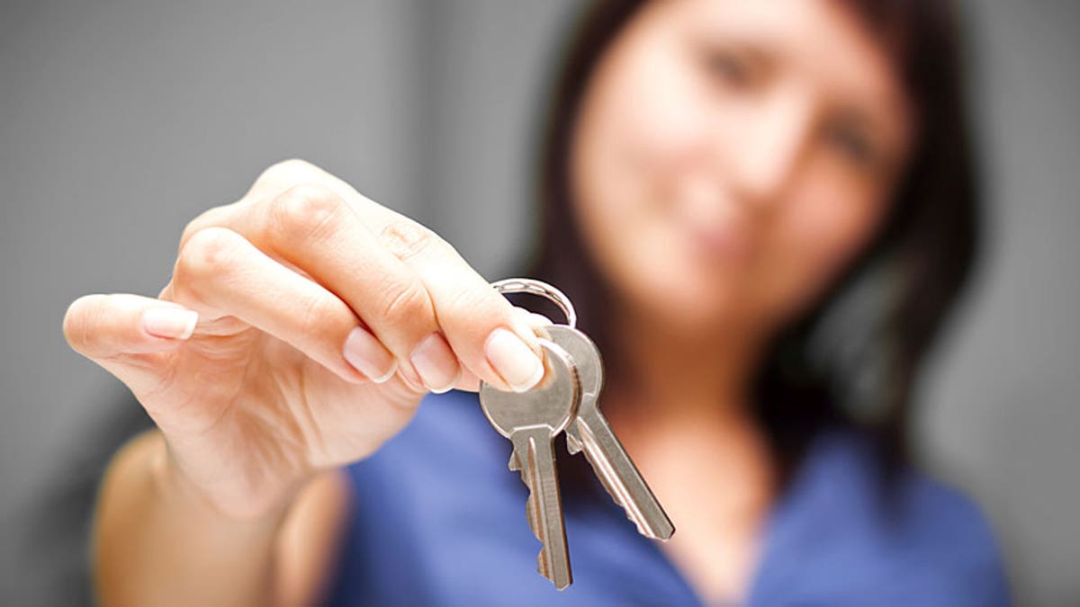 Realtor in empty apartment giving keys