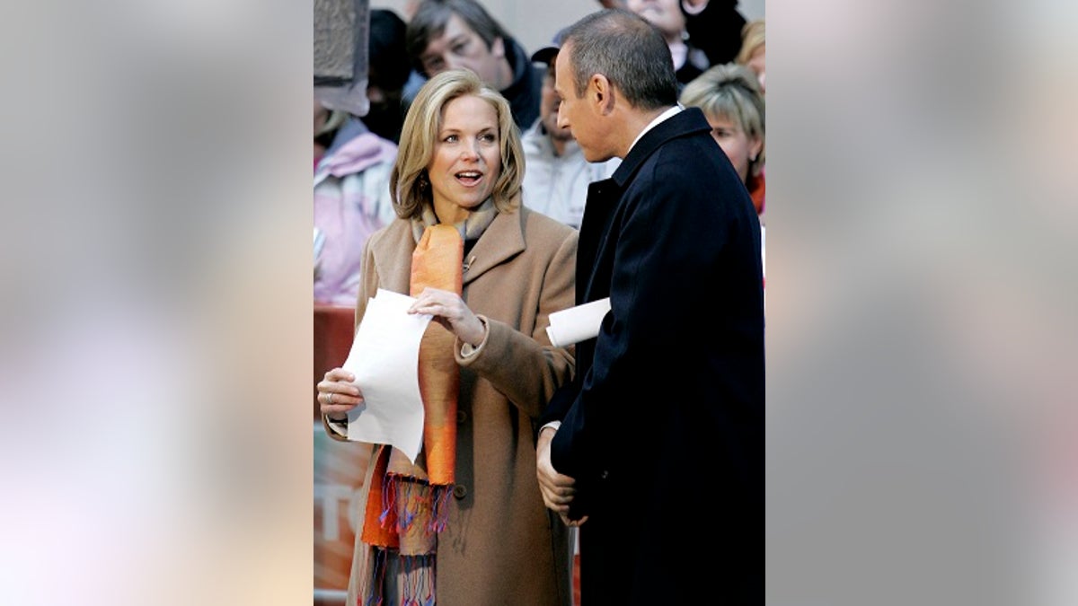 Katie Couric (L) of the NBC Today show chats with her co-host Matt Lauer outside NBC's New York City studios during the broadcast of the April 5, 2006 program. Couric, earlier in the show, told her audience that she will be leaving NBC to join the CBS Evening News where she will become the first woman to solo anchor a network evening newscast. The 49-year-old Couric has been on Today for the past 15 years. REUTERS/Mike Segar - GM1DSHYTTRAB