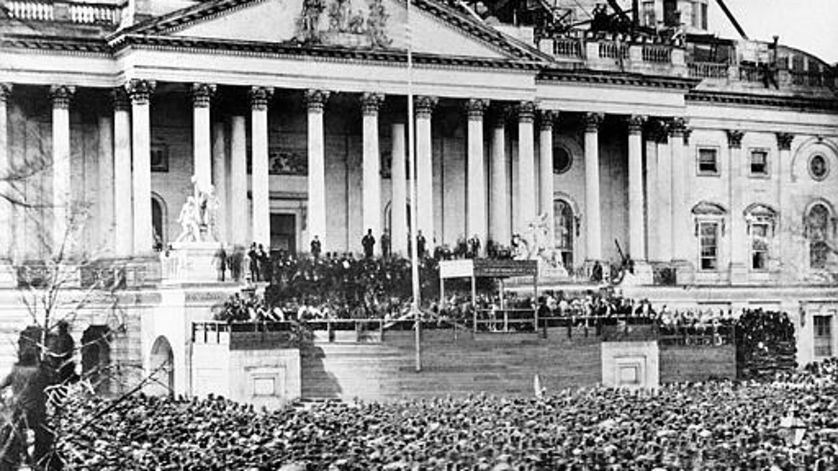 U.S. President Abraham Lincoln stands under cover at center of Capitol steps during his inauguration in Washington, D.C., on March 4, 1861. The scaffolding at upper right is used in construction of the Capitol dome. (AP Photo)