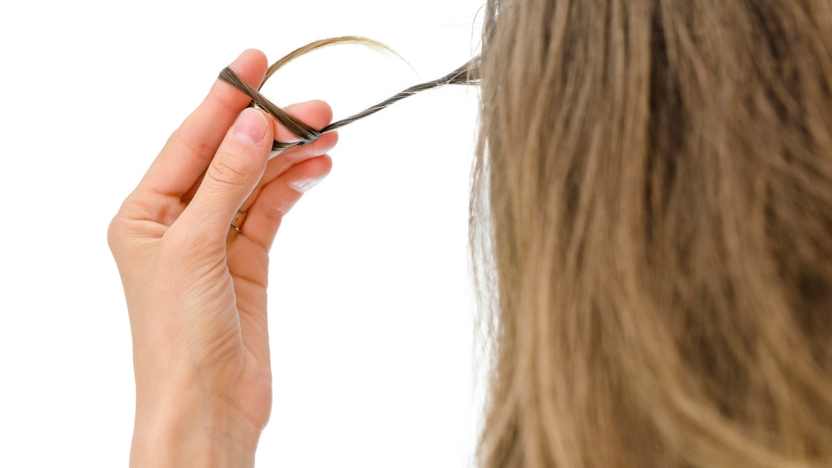 long hair rapunzel syndrome pulling out hair twisting hair nervous hair habit istock large