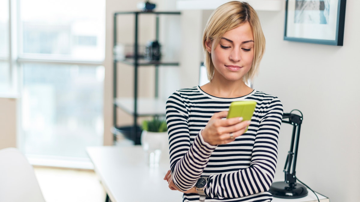 Shot of a attractive woman using her smart phone.