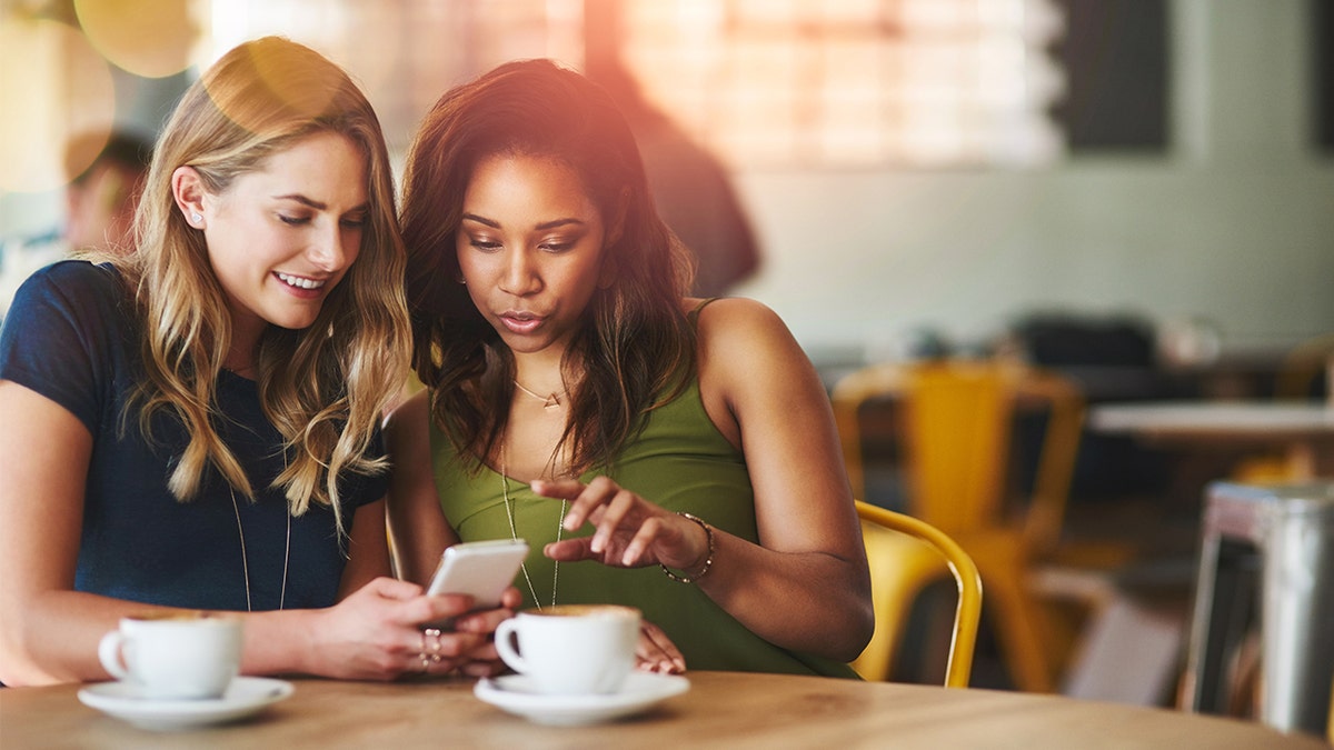 women looking at phone istock