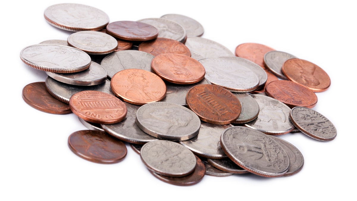 A pile of various American coins (quarters, dimes, nickels, pennies) isolated on white background.