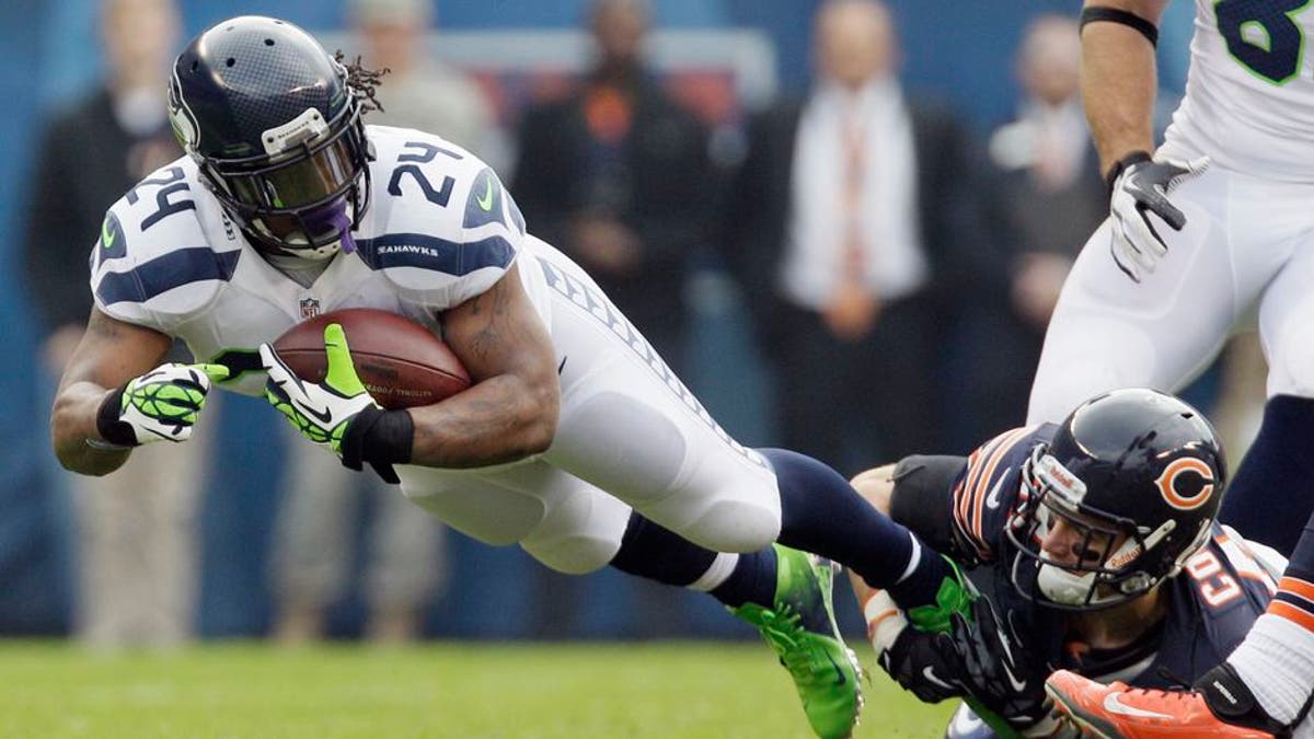 Seattle Seahawks running back Marshawn Lynch (24) is tackled by Chicago Bears free safety Chris Conte in the first half of an NFL football game in Chicago, Sunday, Dec. 2, 2012. (AP Photo/Nam Y. Huh)