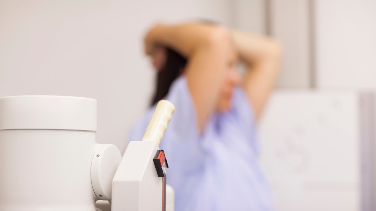 Medical machine next to a patient in an examination room during a breast cancer screening