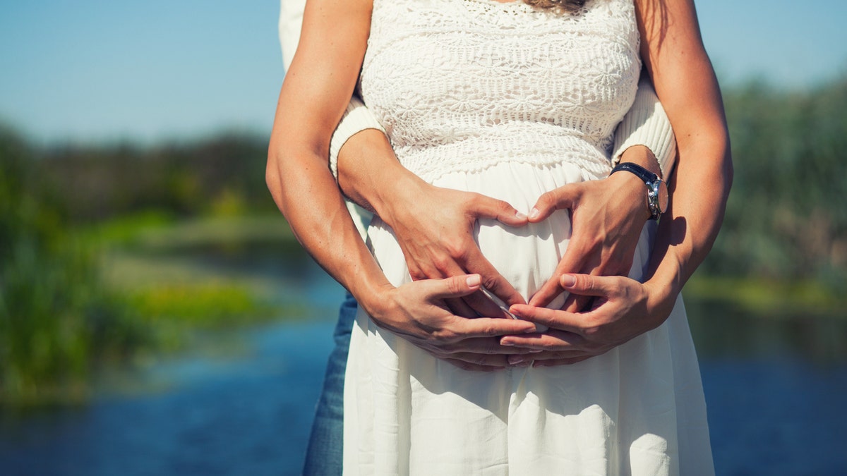 man and wife pregnant istock