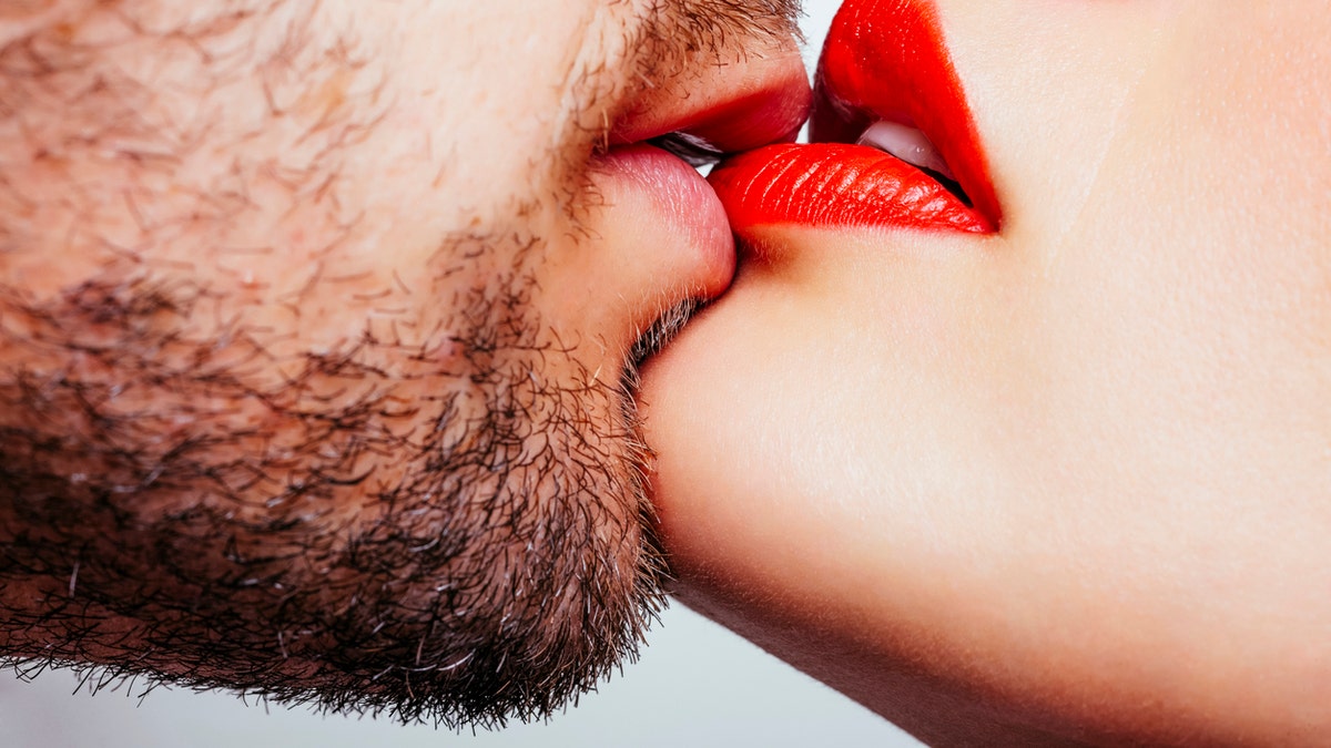 man and woman kissing istock