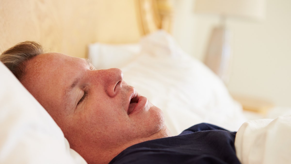 Overweight Man Asleep In Bed Snoring At Home On His Own