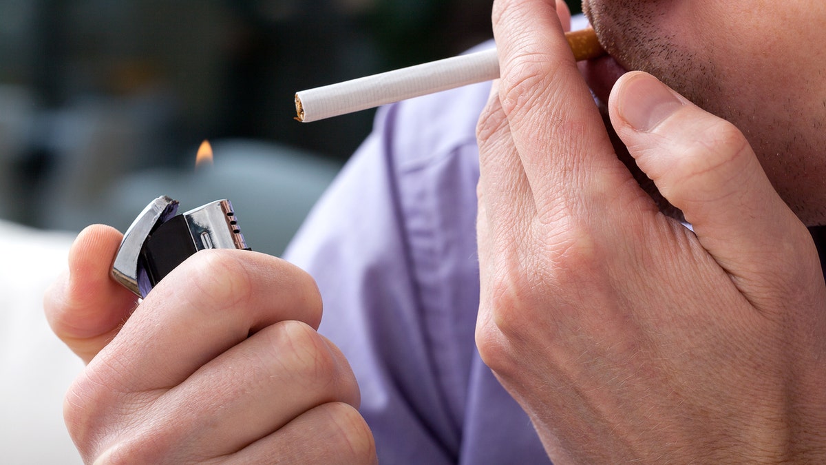 man smoking a cigarette istock