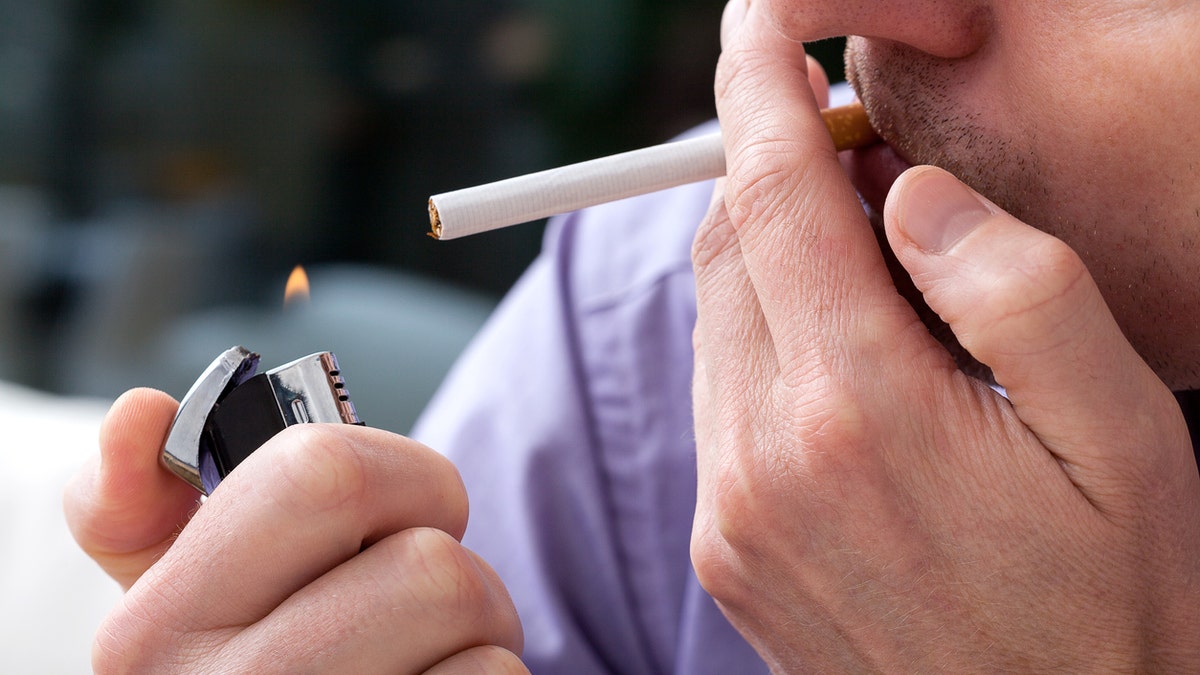 man smoking a cigarette istock