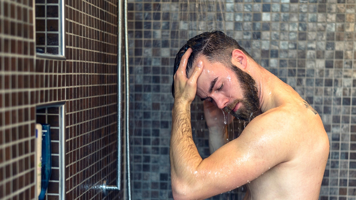 man taking a shower istock