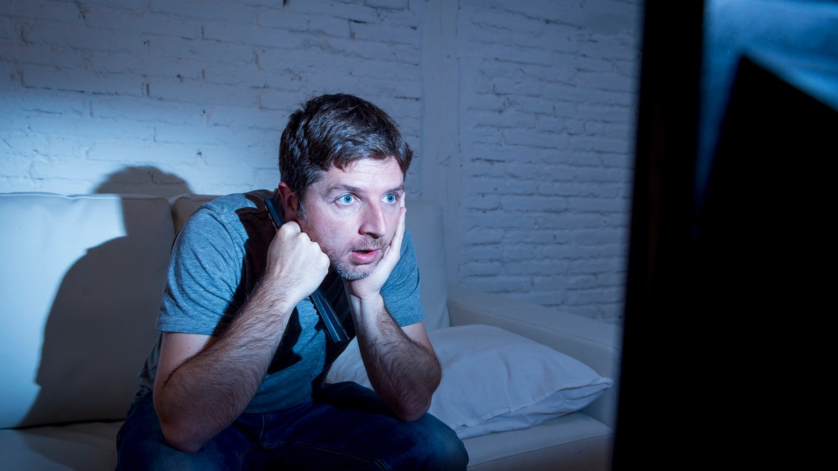 man watching tv alone istock medium