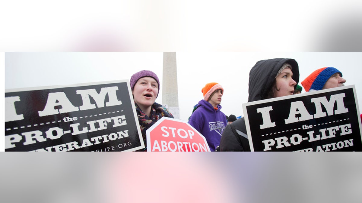 FILE - In this Friday, Jan. 22, 2016, file photo, Michelle Doyle, left, joins the March for Life 2016 rally, commemorating the anniversary of 1973 