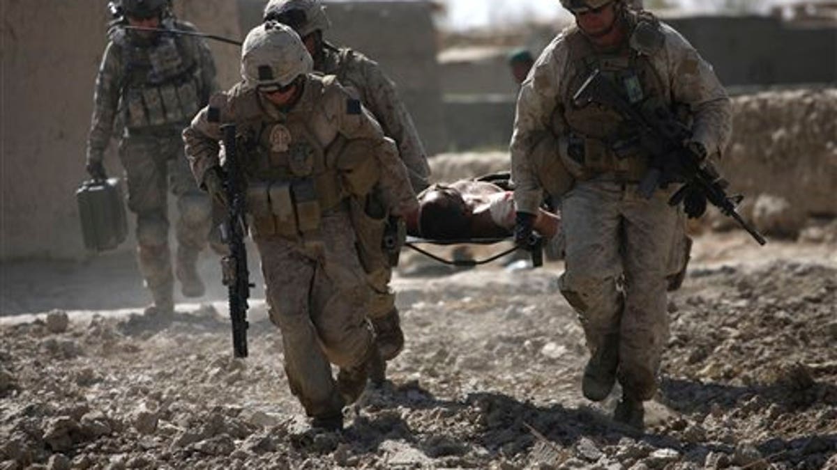 US Service Members carry wounded comrade on stretcher