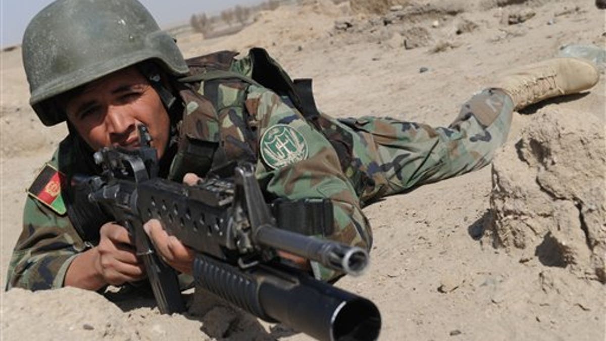 An Afghan National Army (ANA) soldier is alert during an exercise near a military base in Gereshk city of Helmand province on Wednesday Feb. 17, 2010. ( AP Photo/Massoud Hossaini, Pool)