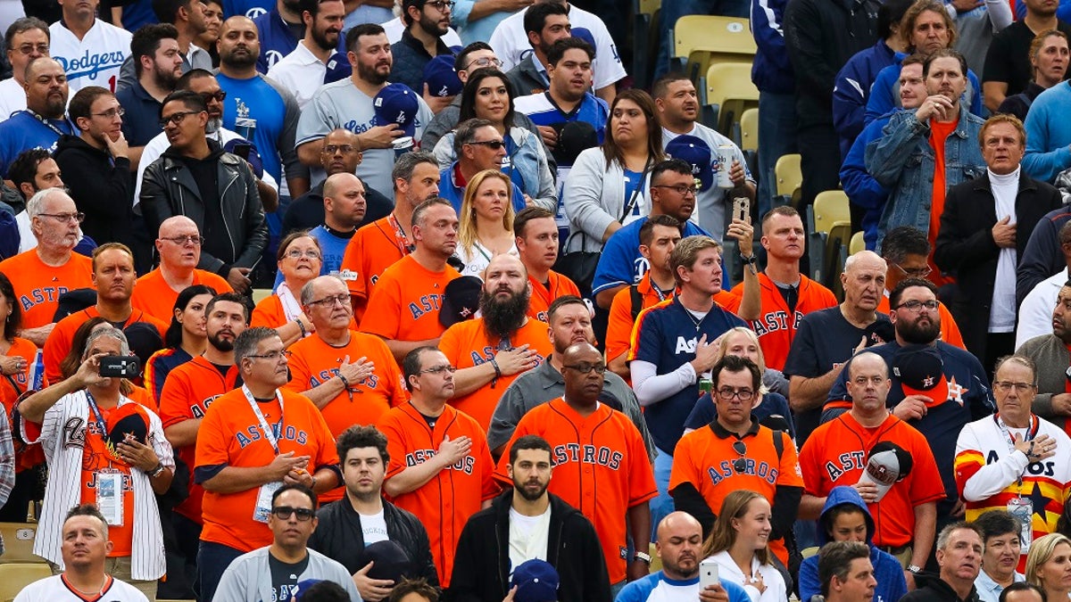 In this Tuesday, Oct. 31, 2017 photo, s section of Houston Astros fans, including those who were sent to Los Angeles by Houston businessman Jim 