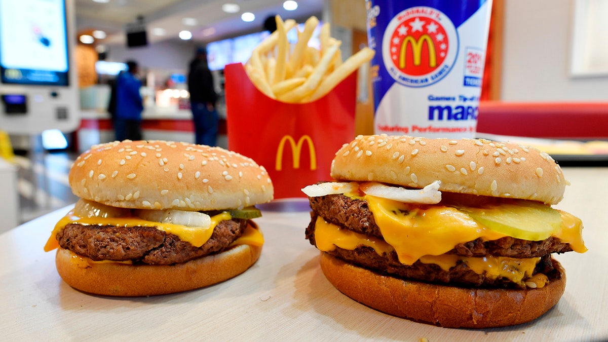 FILE- In this March 6, 2018, file photo, a McDonald's Quarter Pounder, left, and Double Quarter Pound burger is shown with fresh beef in Atlanta. Following years of reformulating at McDonald's, most of the burgers it serves in the U.S. are now preservative-free.As of Wednesday, Sept. 26, the chain says classics like the Big Mac and Quarter Pounder with Cheese are preservative-free, with reformulated buns and sauces. (AP Photo/Mike Stewart, File)